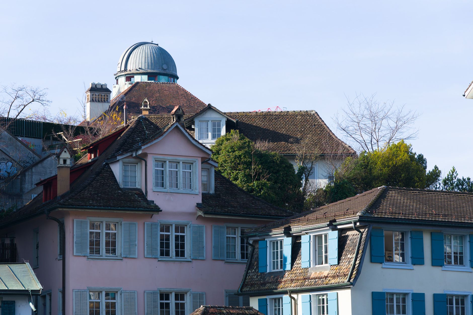 Picturesque historical houses in Zurich under clear blue skies.