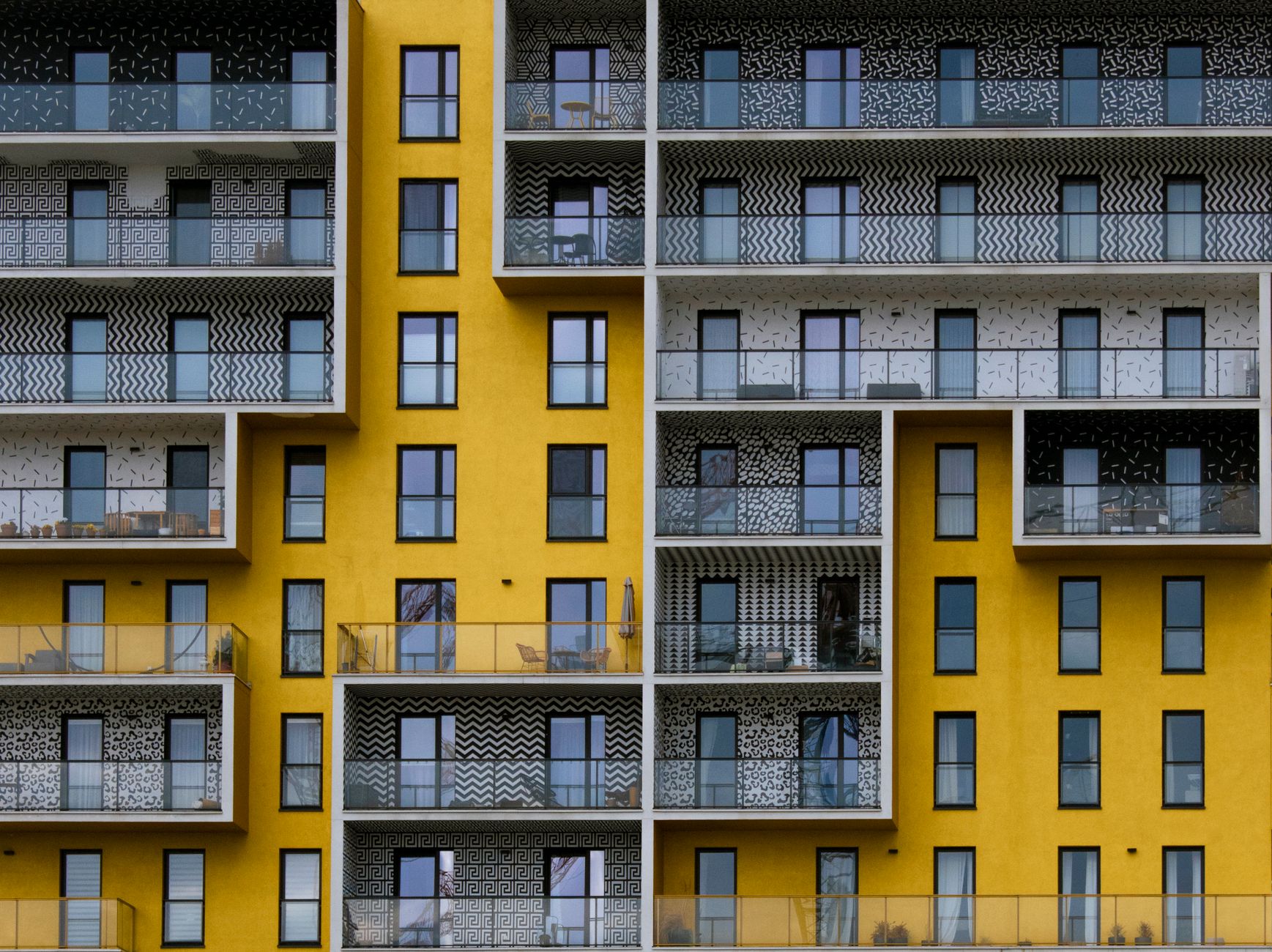 Colorful modern apartment building facade with geometric patterns in Warsaw, Poland.