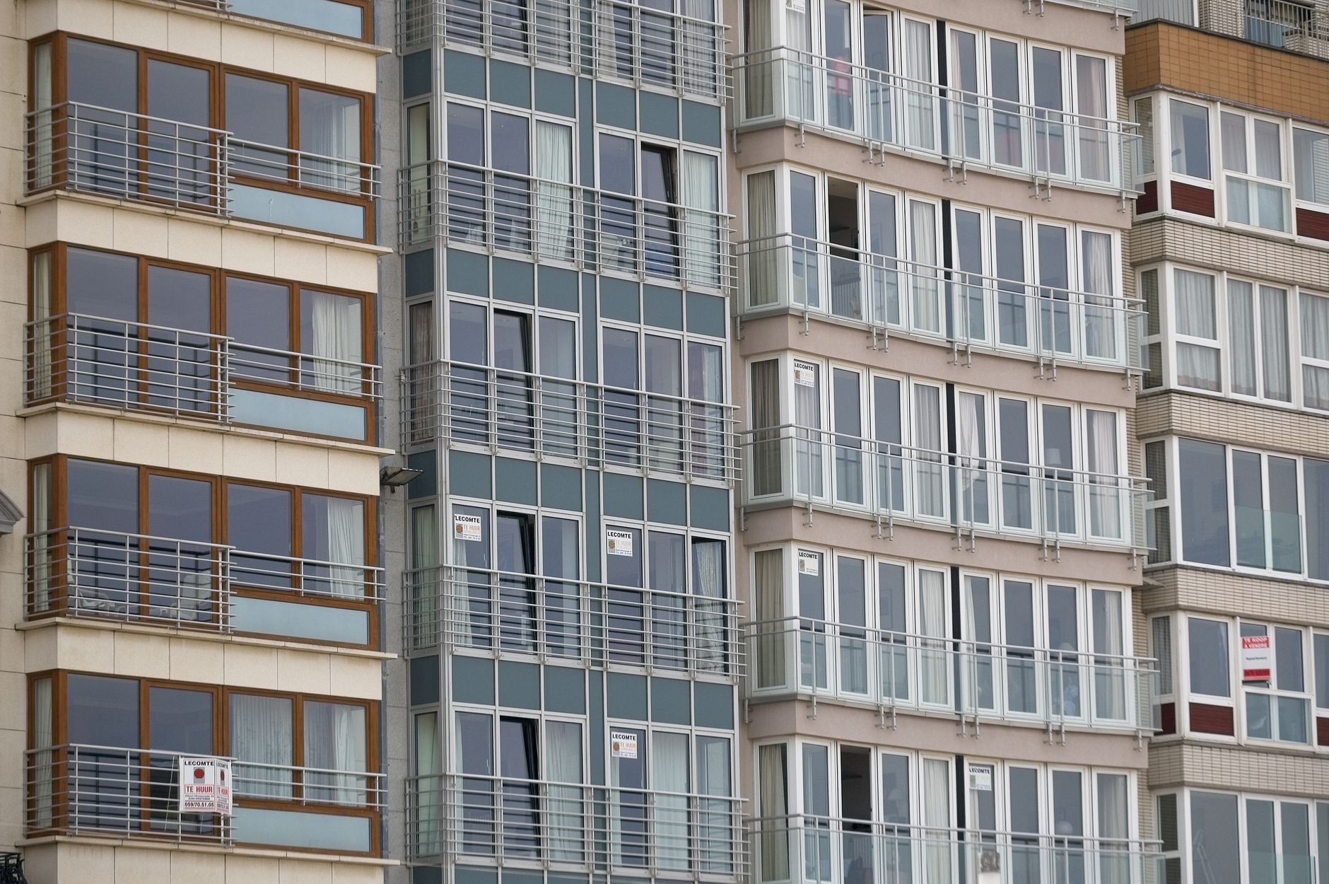 Close-up view of a modern residential apartment building facade with large windows.