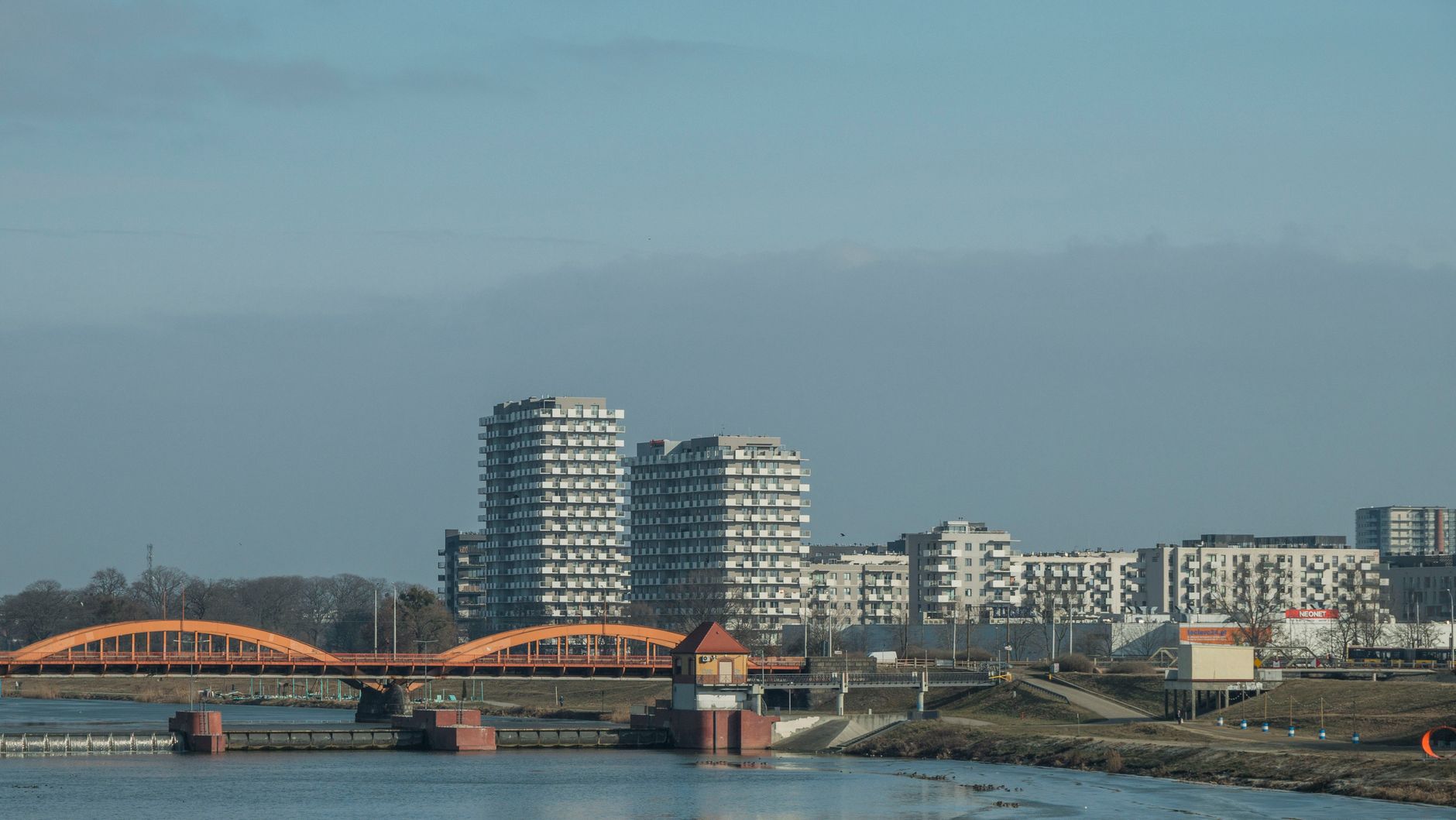 Scenic view of Wrocław skyline with modern buildings and bridge over the river.