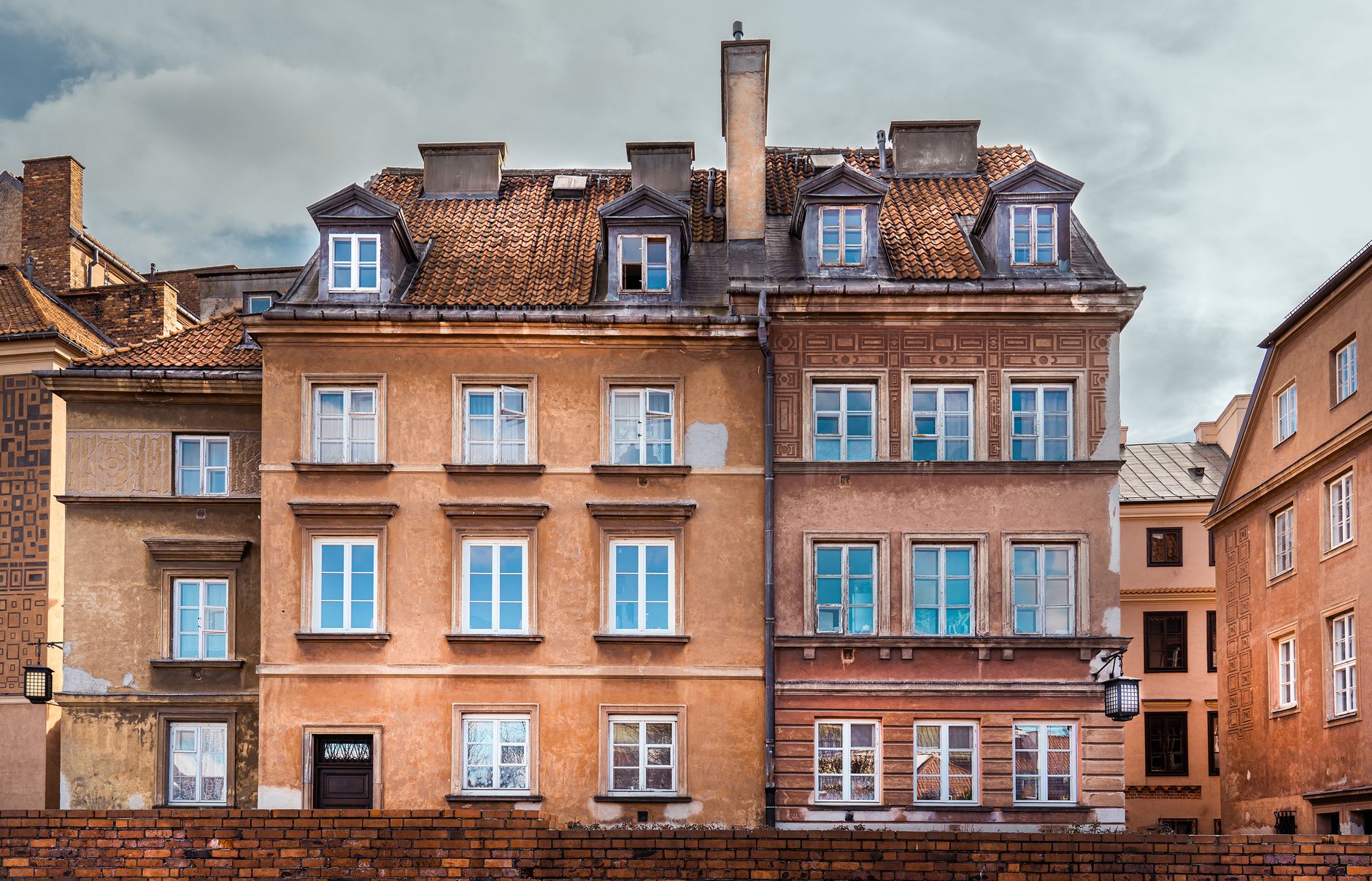 Charming view of historic tenement buildings with rustic facades in Warsaw, Poland.