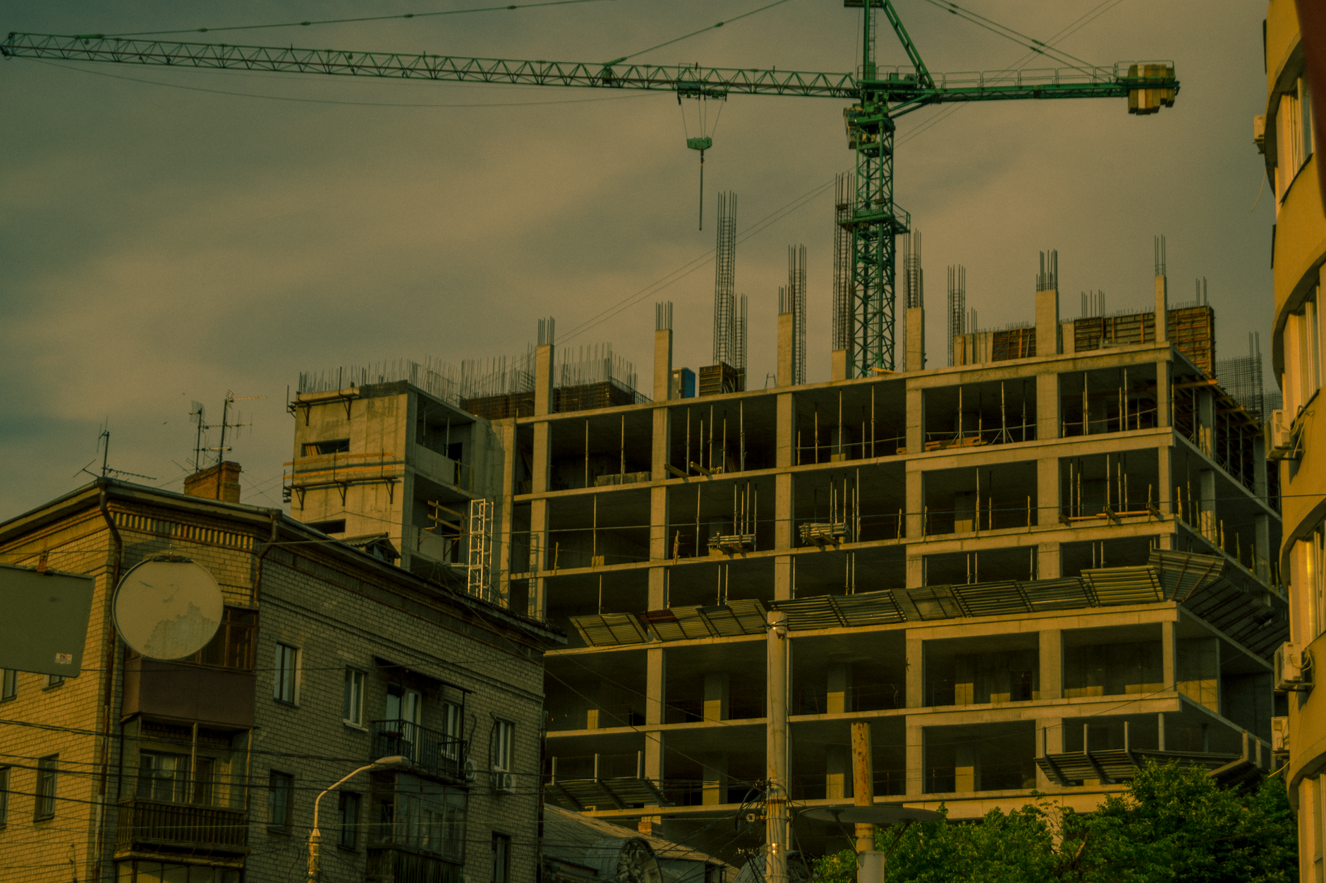 A crane over a modern building under construction in Dnipro, Ukraine.