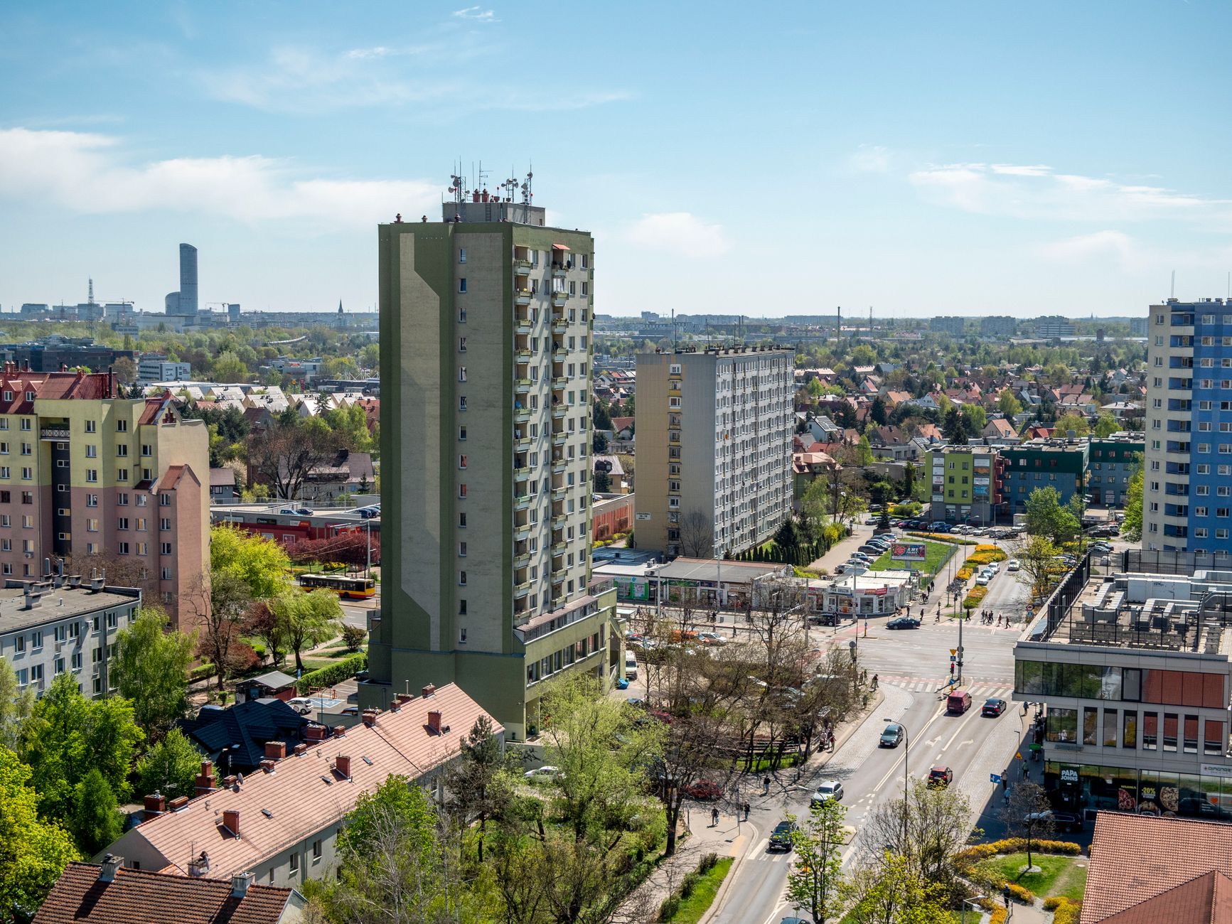 Aerial shot of residential buildings in Wrocław, Poland during spring showcasing urban landscape and architecture.