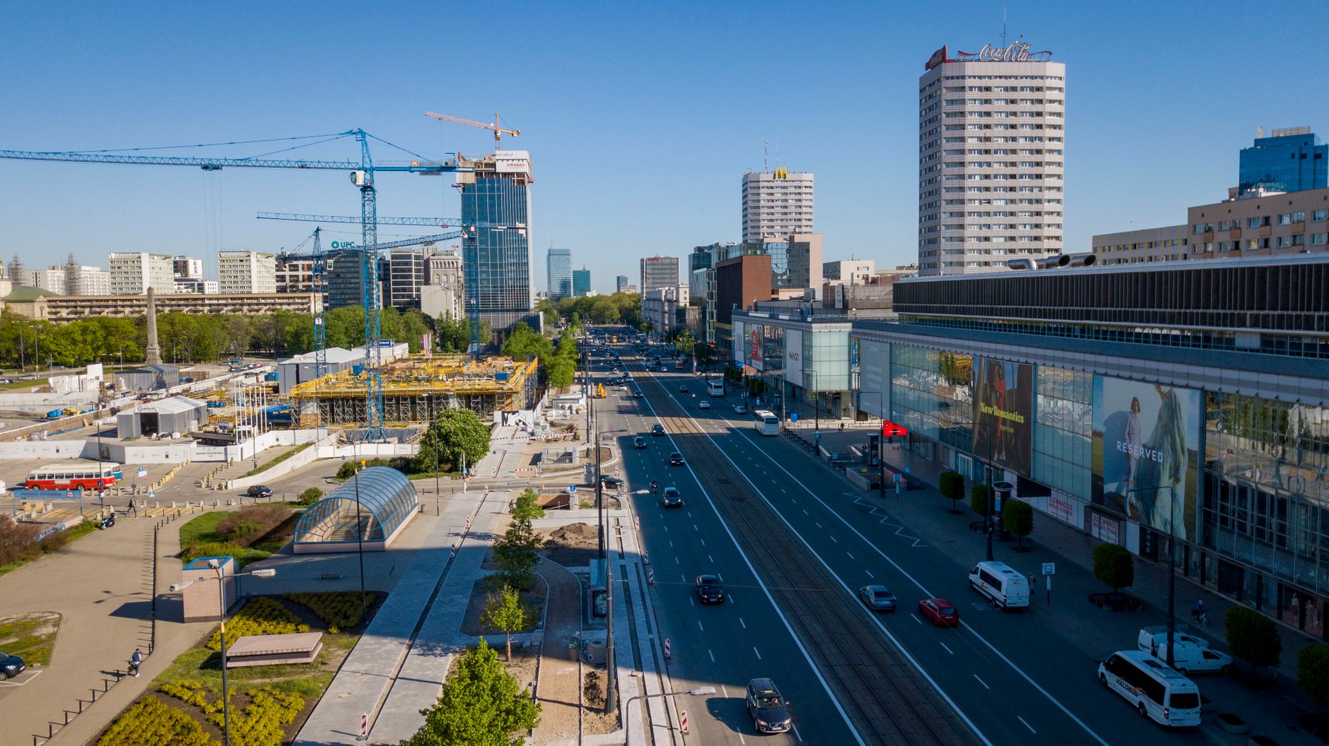 Aerial view of Warsaw cityscape featuring construction, roads, and modern buildings.