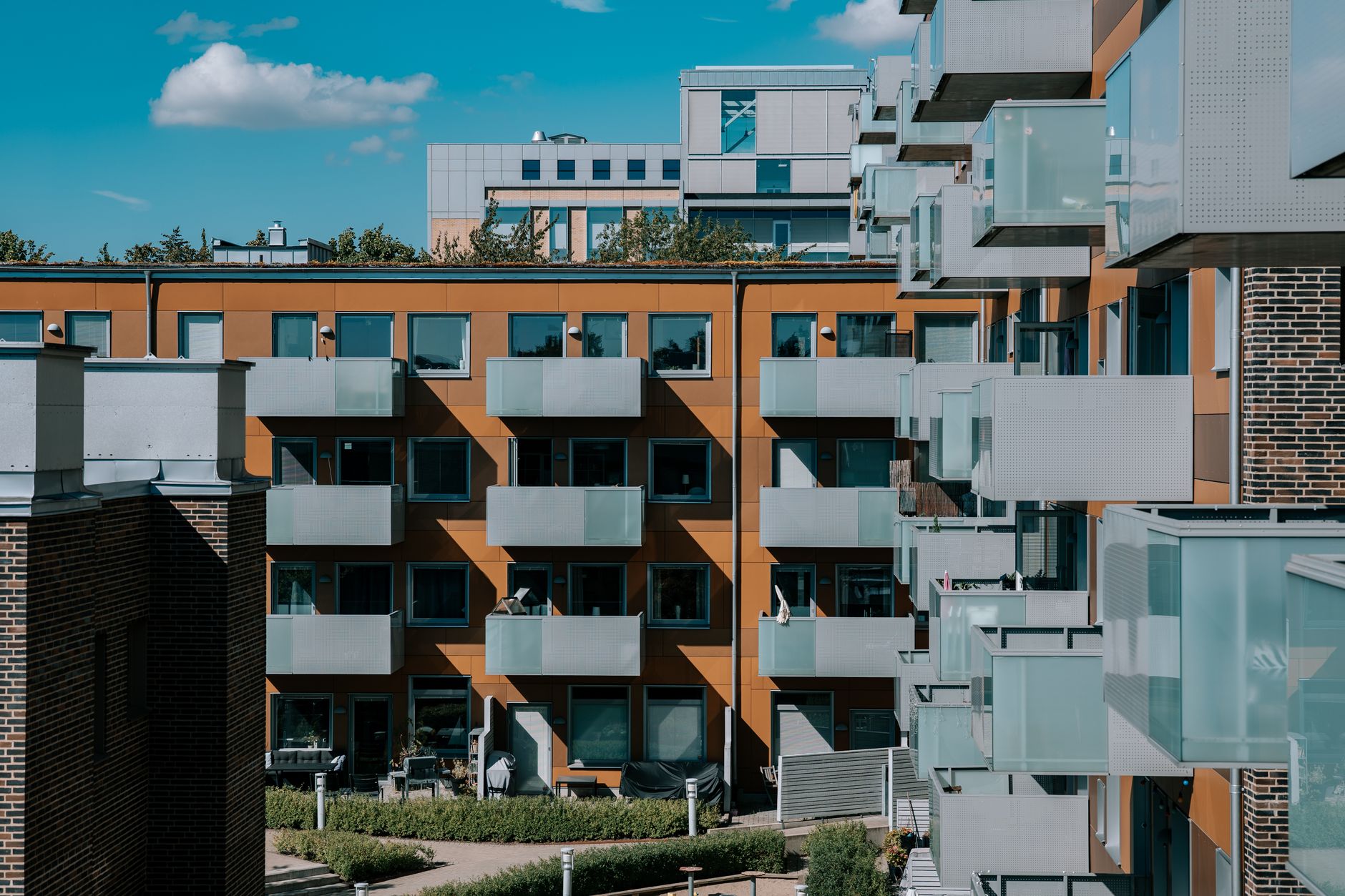 Contemporary apartment architecture with balconies under a sunny sky in Lund, Sweden.