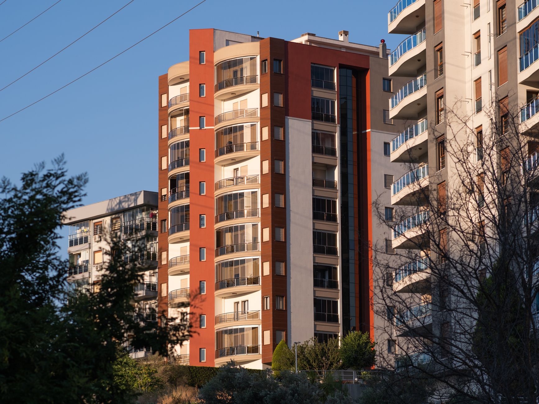 Sunny view of contemporary high-rise apartment buildings in İzmir, Türkiye.