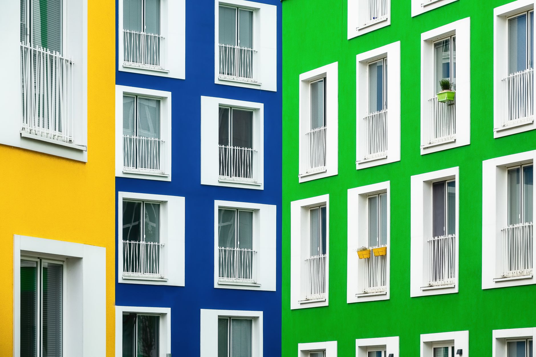 Vibrant modern apartment buildings with colorful facades in yellow, blue, and green.