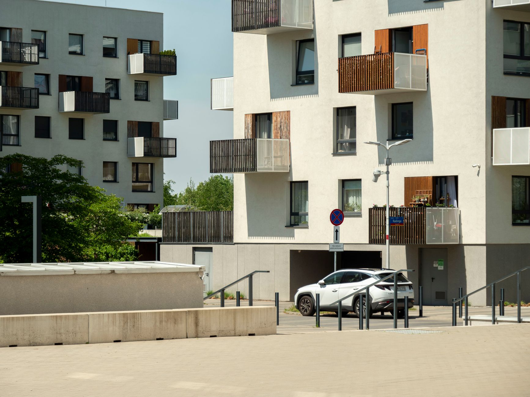 Contemporary residential architecture in Wrocław, Poland, showcasing urban lifestyle on a sunny day.