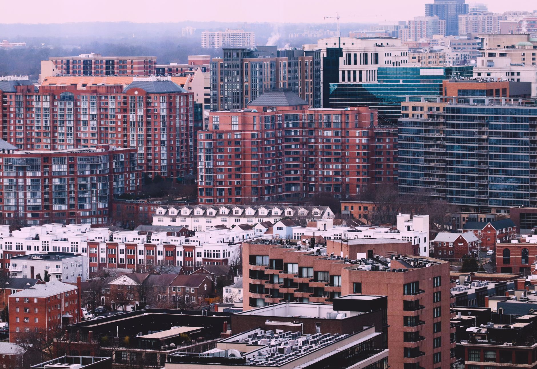 Elevated view of a city skyline with diverse residential and commercial buildings.