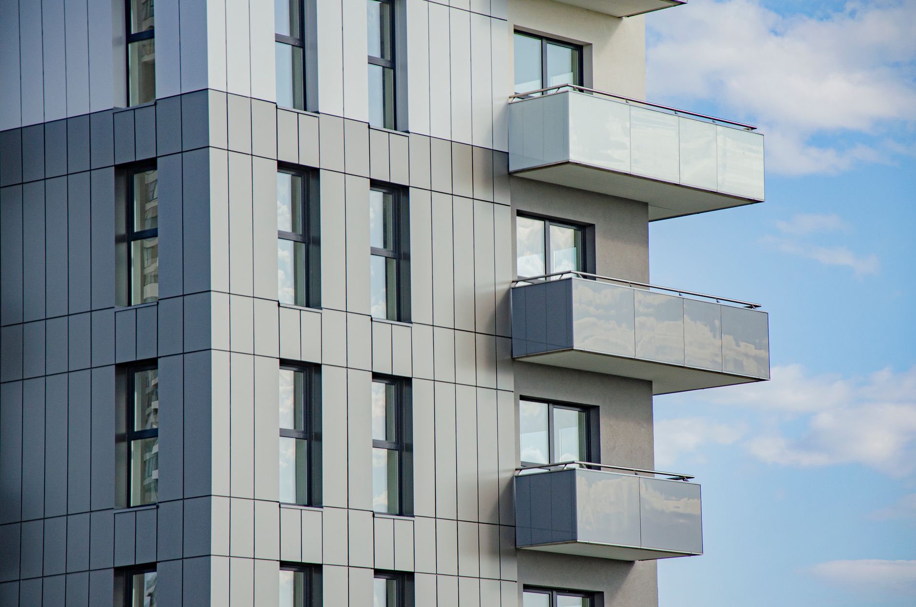 Contemporary architecture featuring balconies and glass windows on a sunny day in Rzeszów.