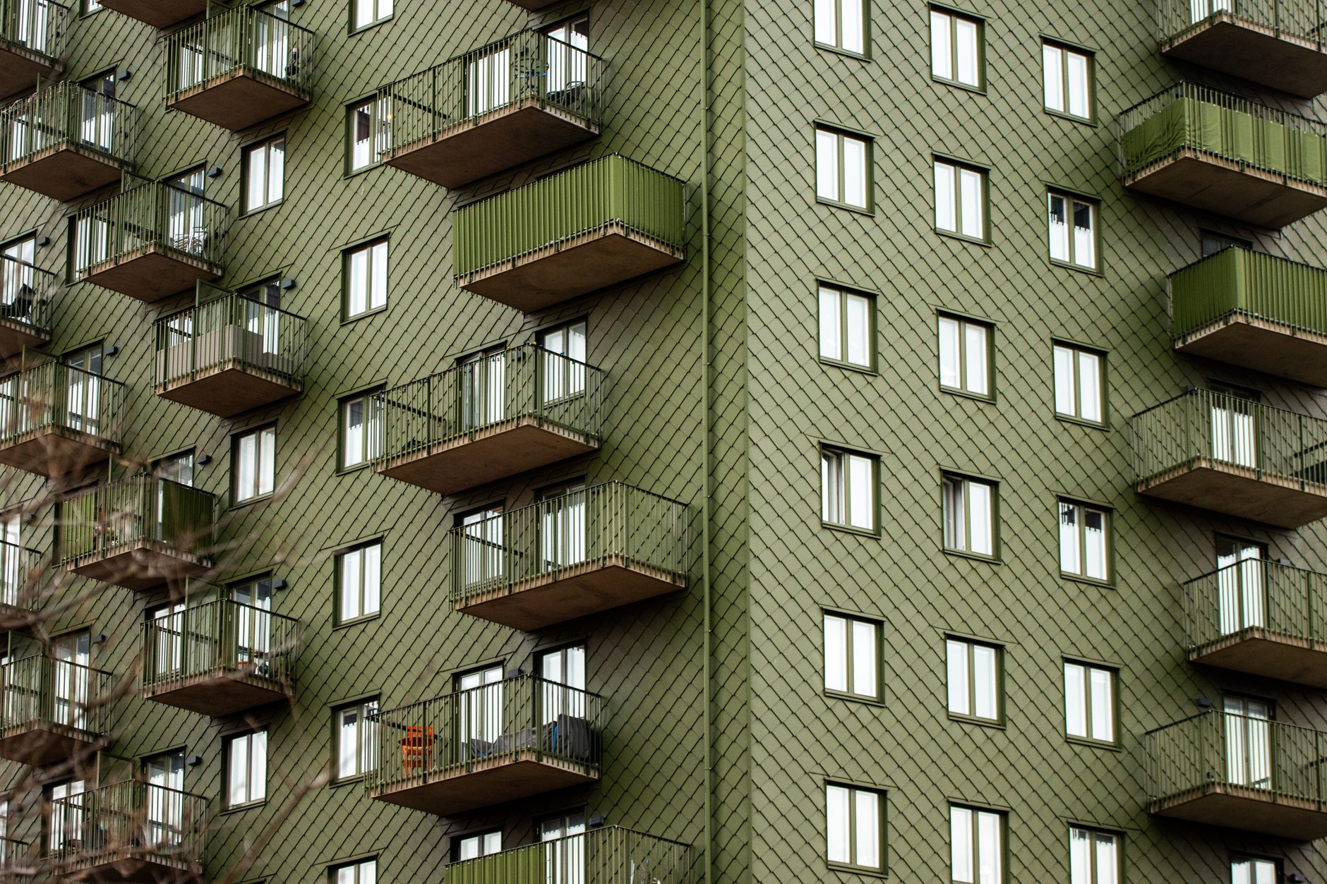 Facade of a modern green apartment building with balconies in Gothenburg, Sweden.