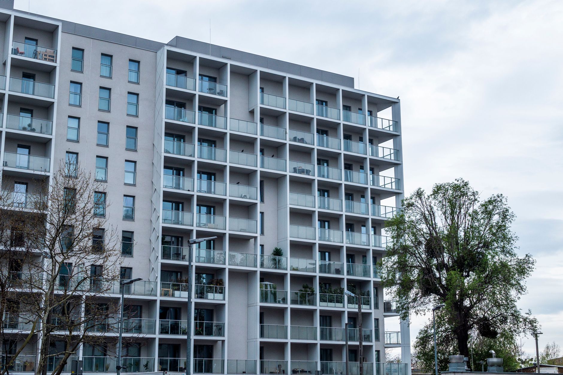 Contemporary multistory apartment building with balconies and large windows.