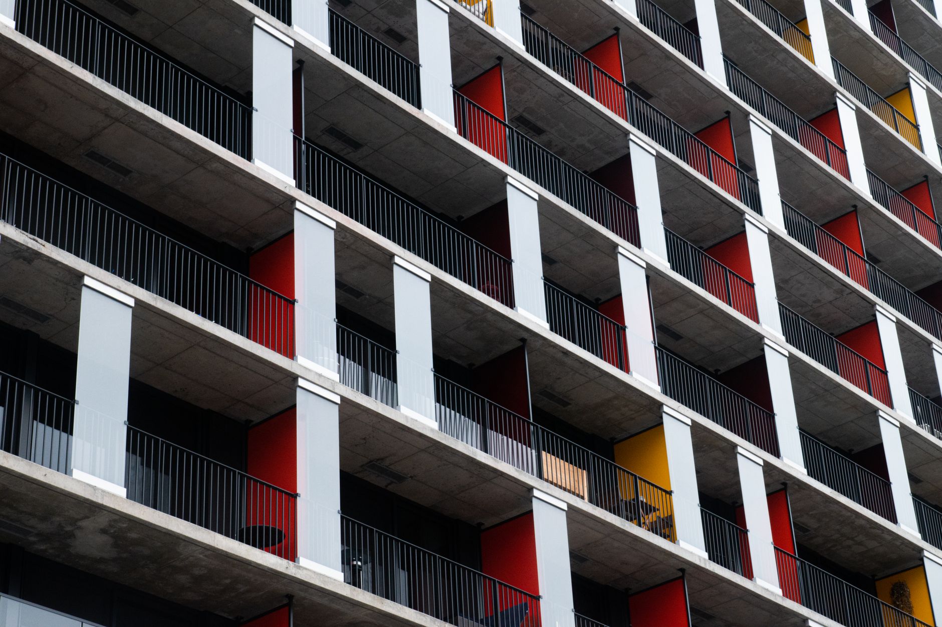 Close-up view of a modern apartment building with vibrant balconies.