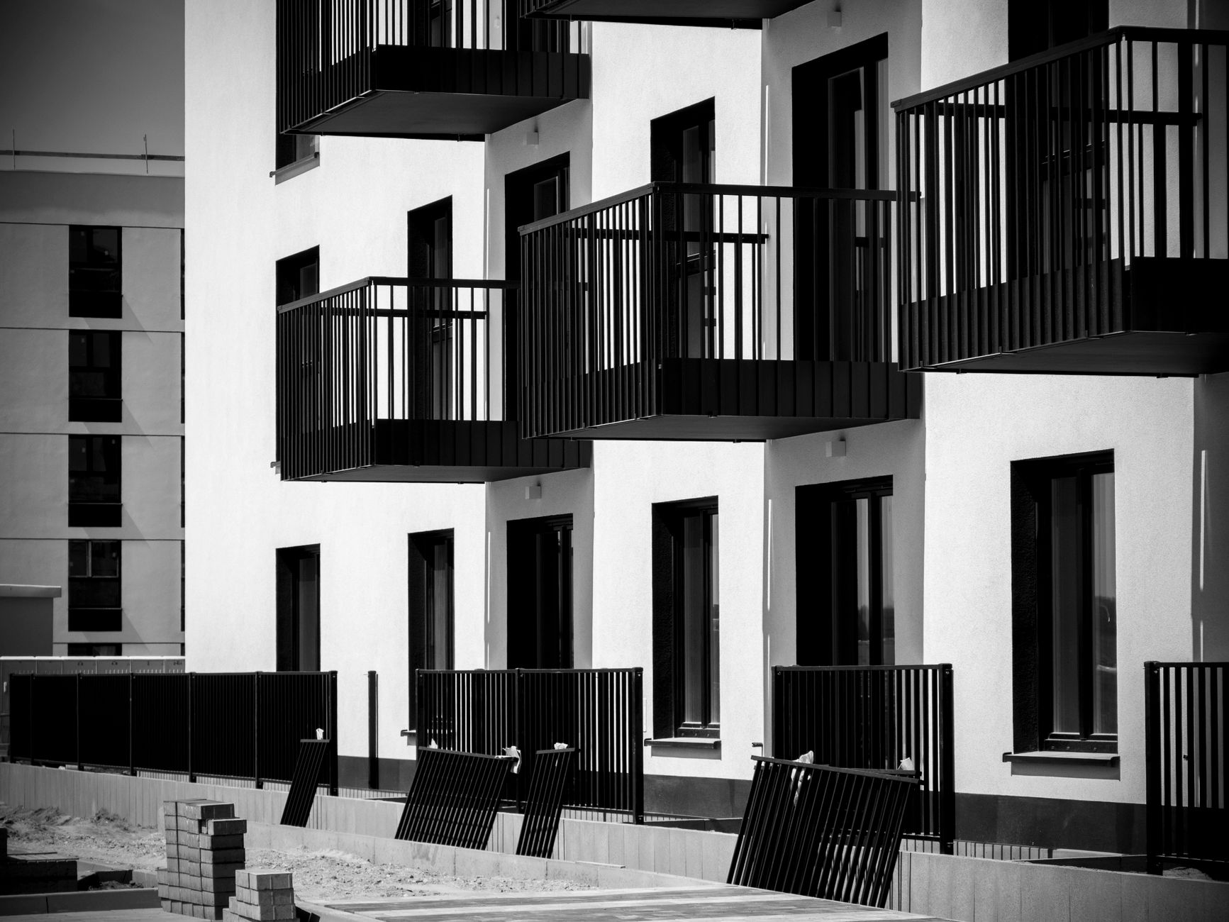 Black and white photo of contemporary apartment balconies in Wrocław, Poland.